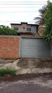 a garage door on a brick wall with a house at Espaço Magalhães in Barra do Garças