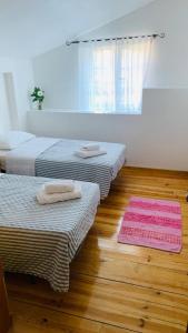 a room with two beds and two mats on the floor at Casa da Neta in Açor