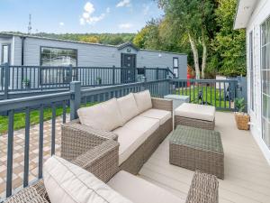 a patio with a couch and chairs on a deck at European Lodge - Uk40848 in Scarborough