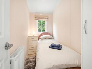 a small bedroom with a bed and a window at European Lodge - Uk40848 in Scarborough
