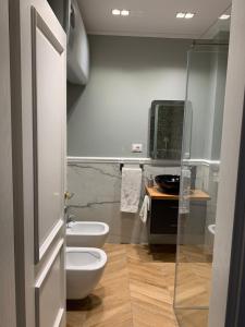 a bathroom with a toilet and a sink at Royal apartament in Durrës +11 photos
