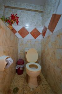 a bathroom with a toilet with a flower on the wall at Yacumama Santa Teresa in Santa Teresa +94 photos