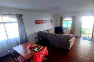 a living room with a couch and a table at Villa Rose in Pereybere