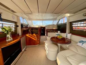 a kitchen and living room of a boat with a table at Tranquility Yachts -a 52ft Motor Yacht with waterfront views over Plymouth. in Plymouth