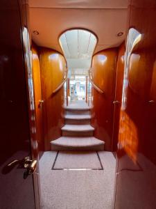 a hallway with stairs in a boat with a ceiling at Tranquility Yachts -a 52ft Motor Yacht with waterfront views over Plymouth. in Plymouth