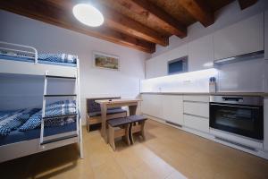 a room with bunk beds and a table and a desk at Apartmány Ludmila - Ludkovice 9 in Ludkovice