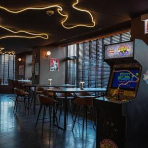 a restaurant with tables and chairs and a video game at The Robey, Chicago, a Member of Design Hotels in Chicago