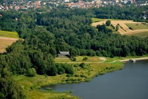 an aerial view of a lake with trees at Natura Park in Połczyn-Zdrój