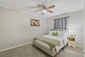 a bedroom with a bed with a ceiling fan at Unit 19 Green Acres Apartment in Enterprise