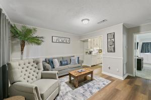 a living room with a couch and a table at Unit 19 Green Acres Apartment in Enterprise
