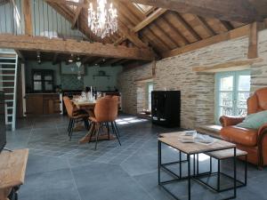 a living room with a couch and a table at La Maison de Madeleine in Léglise