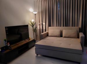 a living room with a couch and a flat screen tv at Bee Homestay - Jesselton Quay Kota Kinabalu in Kota Kinabalu