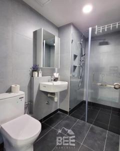 a bathroom with a toilet and a sink and a shower at Bee Homestay - Jesselton Quay Kota Kinabalu in Kota Kinabalu