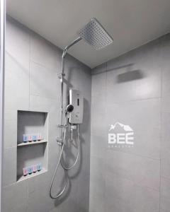a shower with a shower head in a bathroom at Bee Homestay - Jesselton Quay Kota Kinabalu in Kota Kinabalu