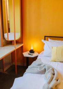a bedroom with a bed and a table with a lamp at Roma Majestic By Mr W in Mexico City