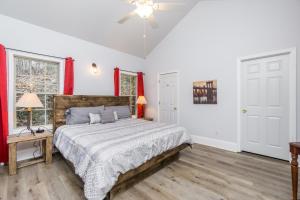 a bedroom with a bed and a ceiling fan at New Listing! Bavarian Cabin - 2 Bedrooms, 8 Minutes to Dahlonega, Hot Tub, Game Room in Dahlonega