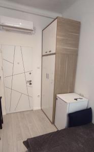 a small room with a closet and a small refrigerator at Astralis Factory Apartments- Mars & Venus in Zagreb