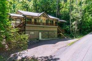 a large house with a balcony and a driveway at New Listing! Bavarian Cabin - 2 Bedrooms, 8 Minutes to Dahlonega, Hot Tub, Game Room in Dahlonega