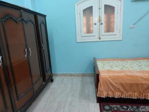 a bedroom with a dresser and a bed and a cabinet at Best appartment in Quseir