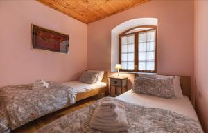 a bedroom with two beds and a window at Kallisti Vitina Home in Vytina
