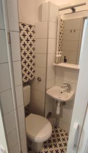 a small bathroom with a toilet and a sink at Astralis Factory Apartments- Mars & Venus in Zagreb