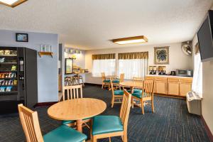 a dining room and kitchen with tables and chairs at Days Inn by Wyndham Hurley in Hurley