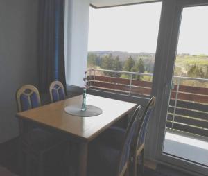 a table and chairs in a room with a window at Ferienwohnung Himmelblau - Altenau Harz in Altenau