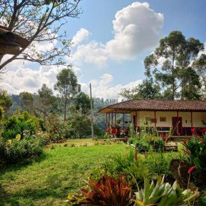 ein Haus mit Garten davor in der Unterkunft Hostal rural la montaña alquiyapura in Salento