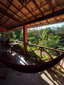 a hammock on the porch of a house at Casa Colmeia in Lençóis