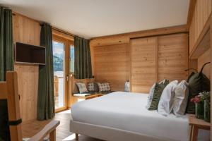 Postel nebo postele na pokoji v ubytování Hotel Baita Dei Pini
