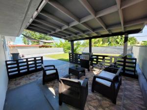 a patio with benches and tables and a table and chairs at Luxury 3-bedrooms near airport in San Juan in San Juan