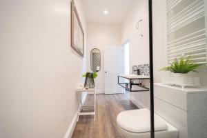 a bathroom with a white toilet and a sink at The Apartment - Brand new, stylish & central in Shanklin