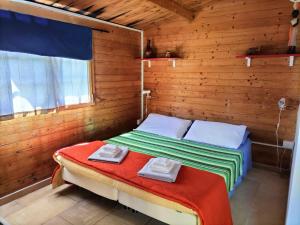 a bedroom with a bed in a wooden wall at Breezes B&B in Conca Specchiulla