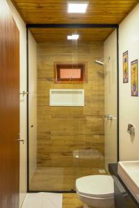 a bathroom with a shower with a toilet and a sink at POUSADA 05 LUAS URUBICI in Urubici