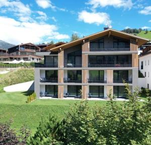 a large building with a lot of windows at Residence Le Fostü in San Vigilio Di Marebbe