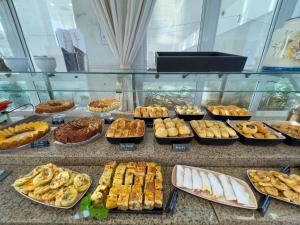 a buffet of different types of food on a counter at Praiamar Ponta Negra Hotel in Natal