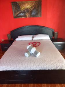 a teddy bear laying on top of a bed at Chez Mimi in Rodrigues Island