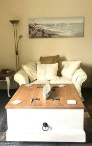 een woonkamer met een bank en een salontafel bij City living maisonette, The Nest in Swansea