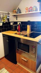 a kitchen with a stove and a counter top at The Cabin: Great Views,Garden,Close to Town, Quiet in Hebden Bridge