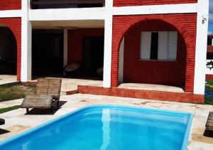 una piscina frente a una casa en CASA DE PRAIA (PE NA AREIA), en Caponga