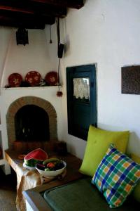 a living room with a couch and a fireplace at Traditional Cycladic house in Serifos Chora