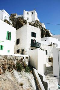 a group of white buildings on top of a mountain at Traditional Cycladic house in Serifos Chora