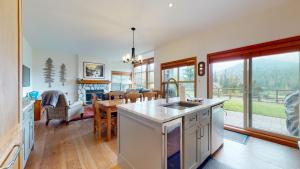 eine Küche und ein Wohnzimmer mit einem Tisch und einem Esszimmer in der Unterkunft Beautiful Golf Course Setting by Harmony Whistler in Whistler