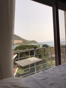 a bedroom with a bed and a view of the ocean at Leman Apart in Bodrum City