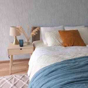 A bed or beds in a room at Narva Relax Apartment