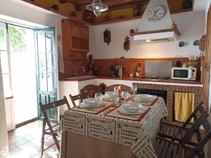 a kitchen with a table with a table cloth on it at La Era de San Blas in Fuentes de León