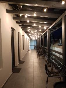 a hallway with chairs and lights in a building at URBANIST Guest House in Călimăneşti