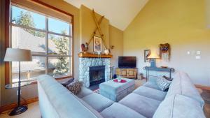 a living room with a couch and a fireplace at Golf Course & Mountain Views by Harmony Whistler in Whistler