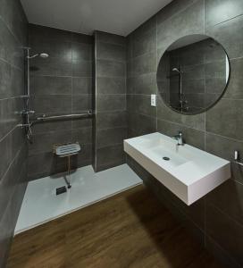 a bathroom with a white sink and a mirror at A Estreliña in Sigüeiro