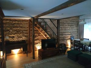 a living room with a fireplace and a television at Casa da Tia Guida in Golegã
